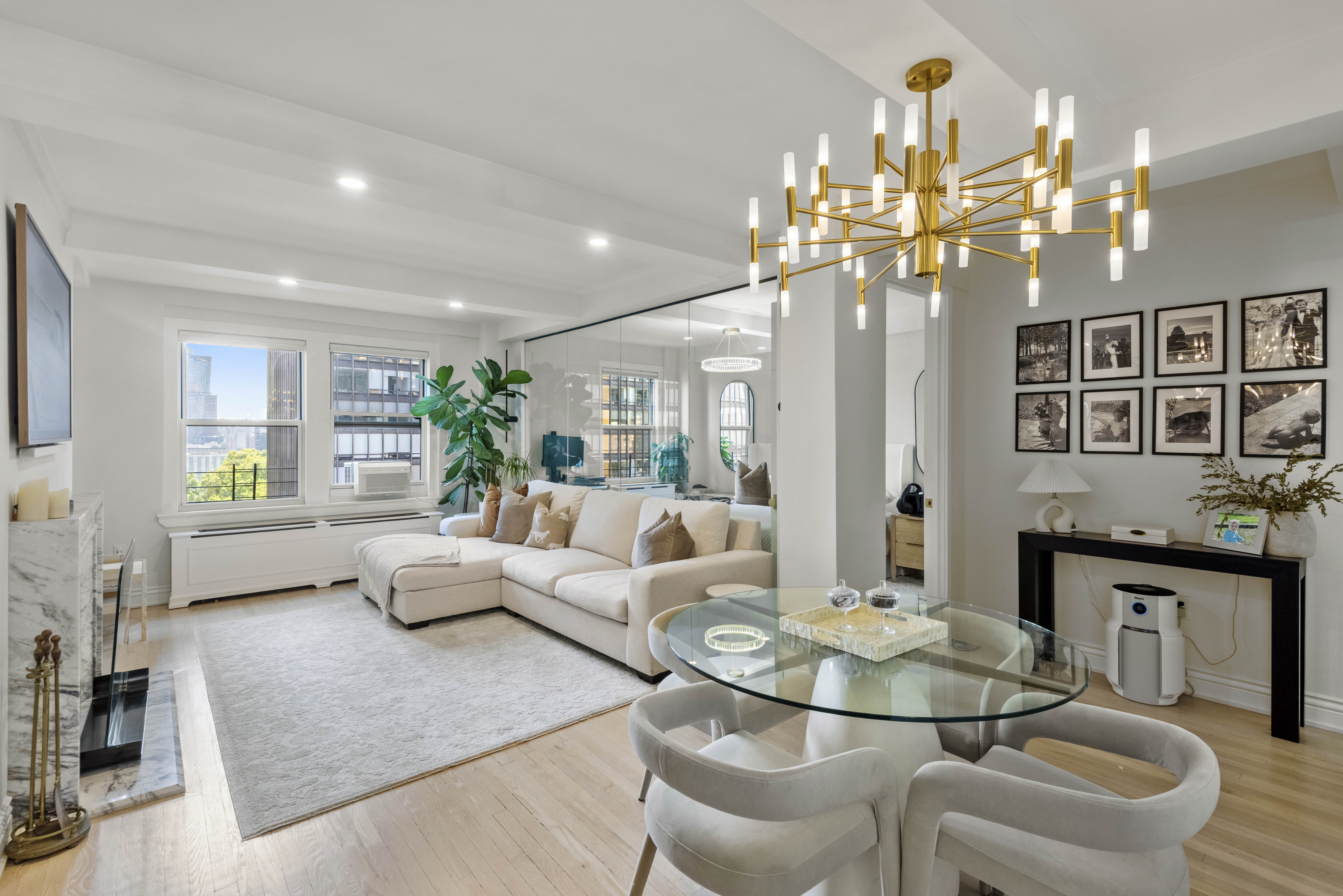 a living room with fireplace furniture and a chandelier