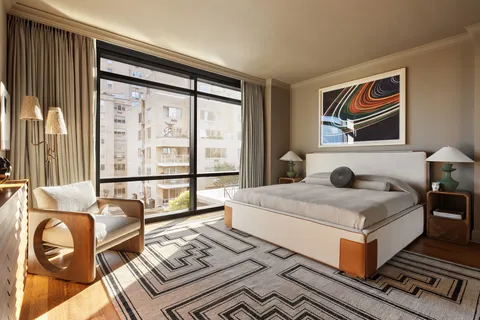 a bedroom with a bed and glass window