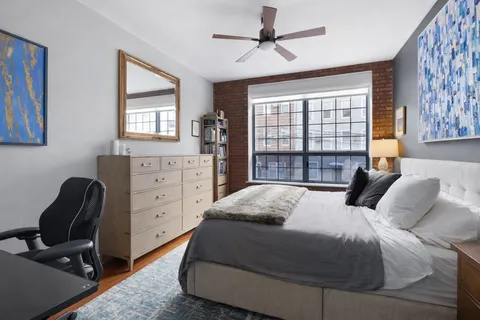 a bedroom with a bed and a window