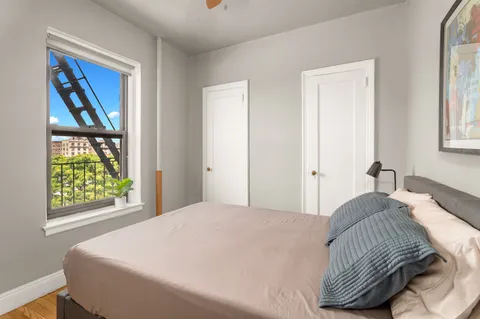 a bedroom with a bed and a window