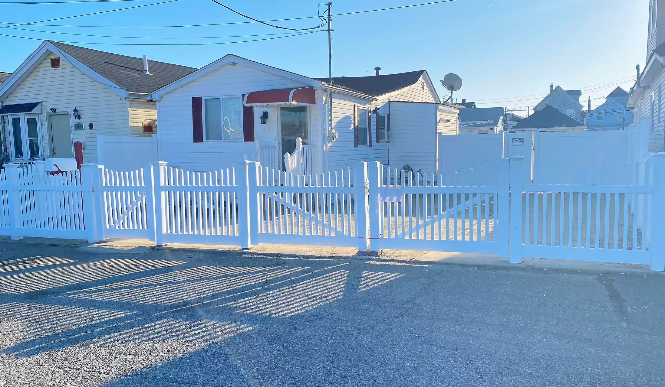 a front view of a house with a street