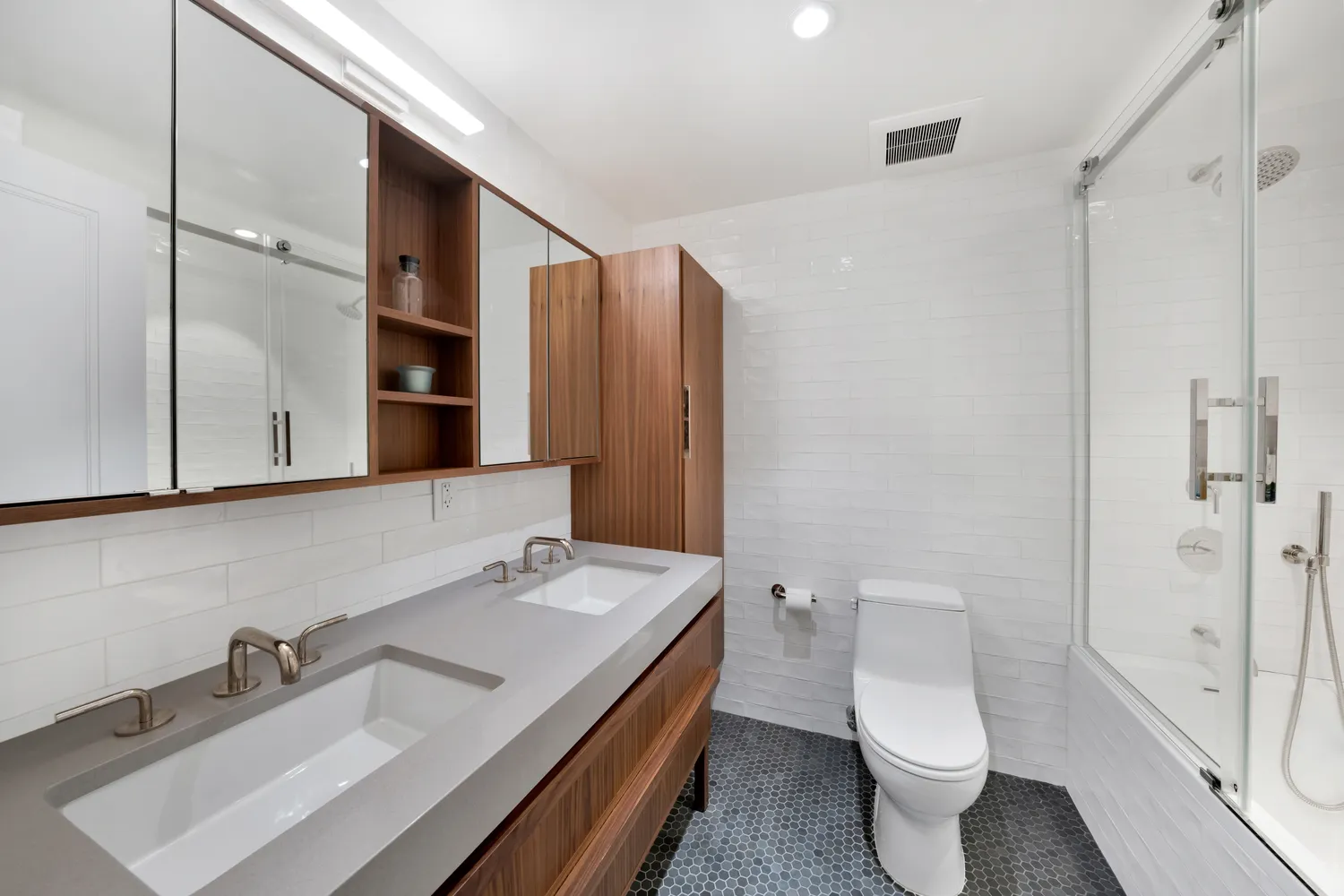 a bathroom with a sink toilet and shower