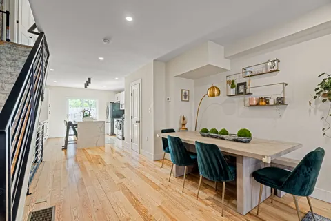 a dining room with furniture and wooden floor