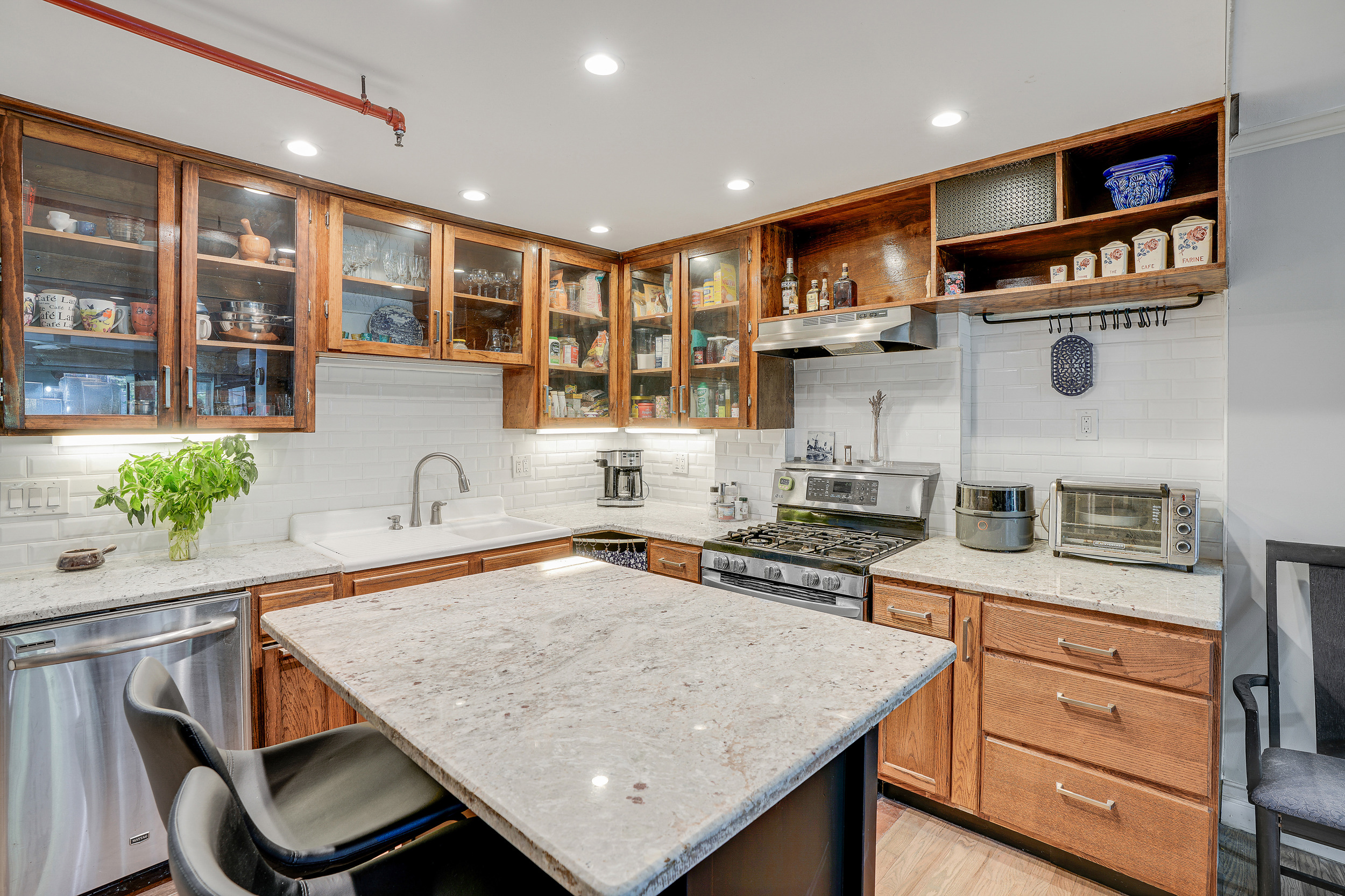 205 Edgecombe Avenue Manhattan, NY 10030 - Photo 4 of 21 a kitchen with stainless steel appliances granite countertop a stove refrigerator sink and cabinets