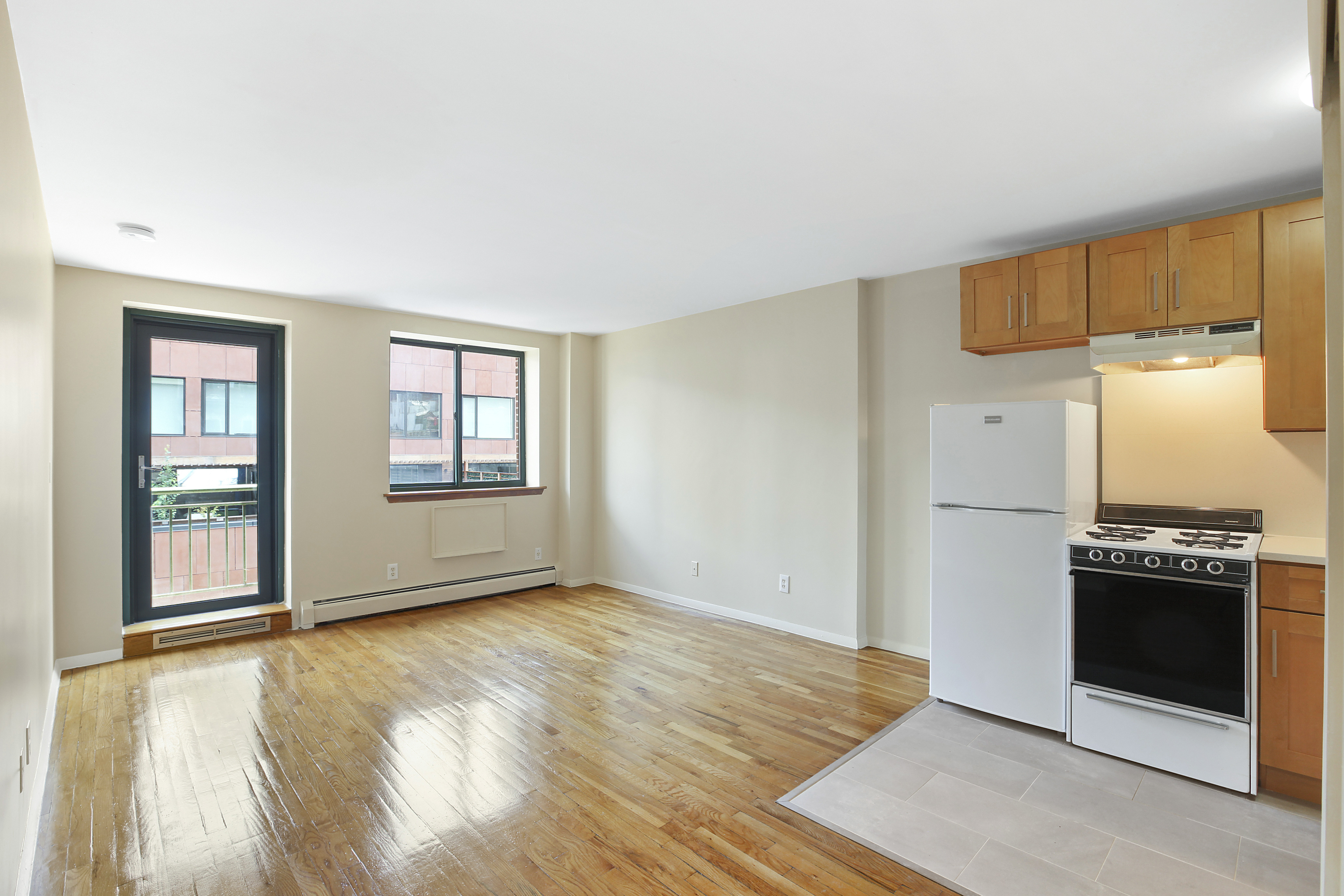 325 West 51st Street, Unit 4C Manhattan, NY 10019 - Photo 1 of 7 an empty room with a kitchen