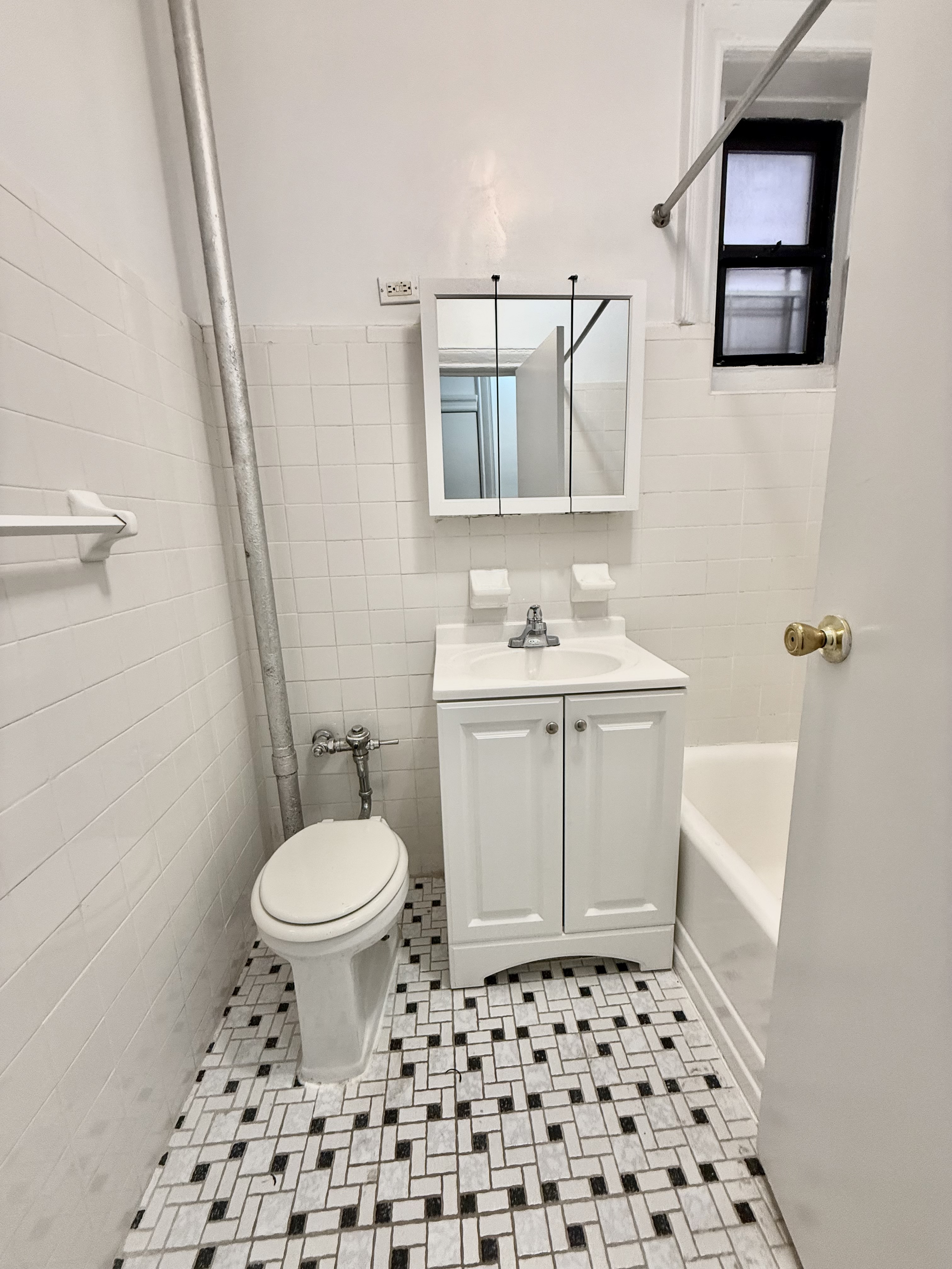 30 Seaman Avenue, Unit 1 Manhattan, NY 10034 - Photo 2 of 5 a bathroom with a sink toilet and shower