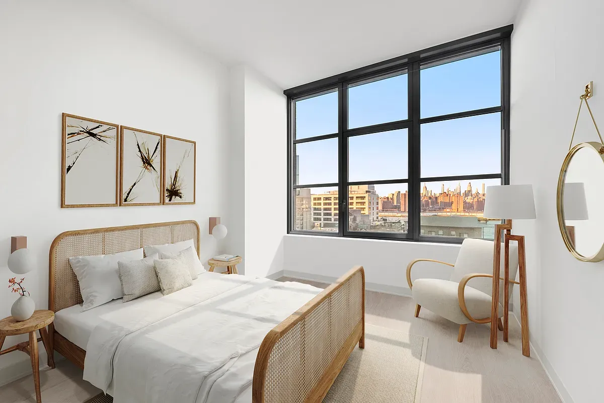 a bedroom with a bed and a large window