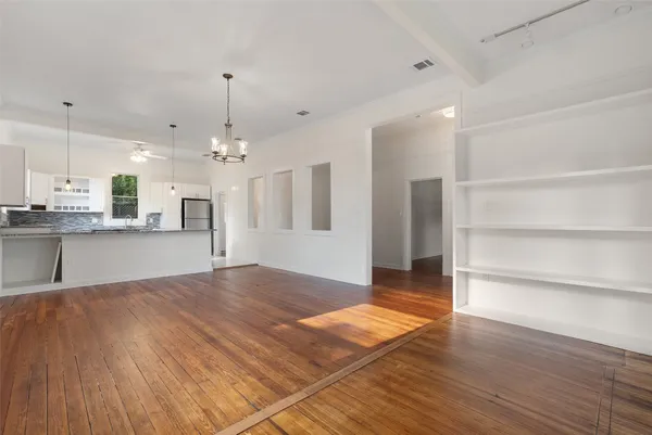 a view of a kitchen with granite countertop cabinets and wooden floor