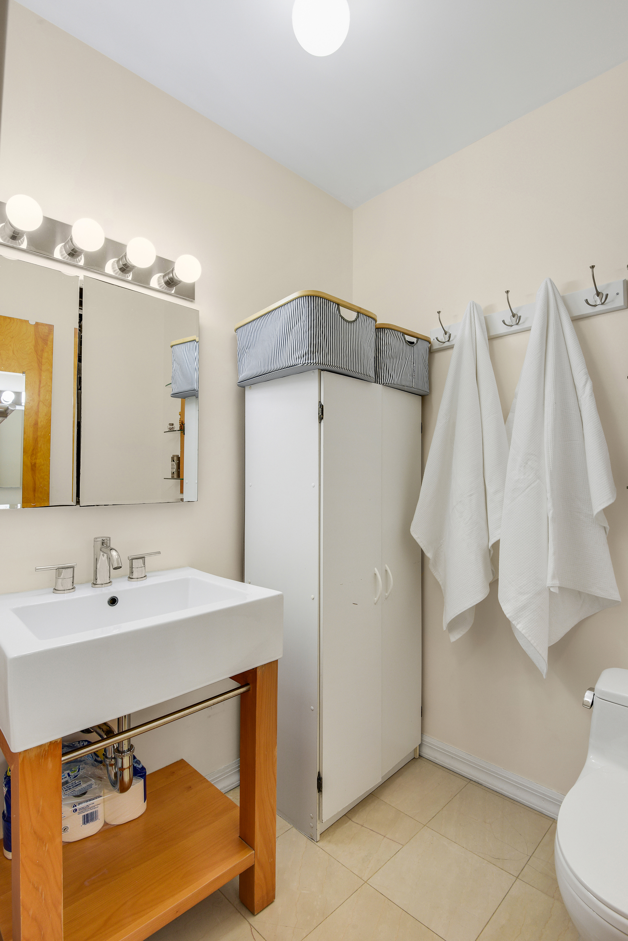 335 Warren Street, Unit 102 Brooklyn, NY 11201 - Photo 12 of 20 a bathroom with a sink vanity and a mirror