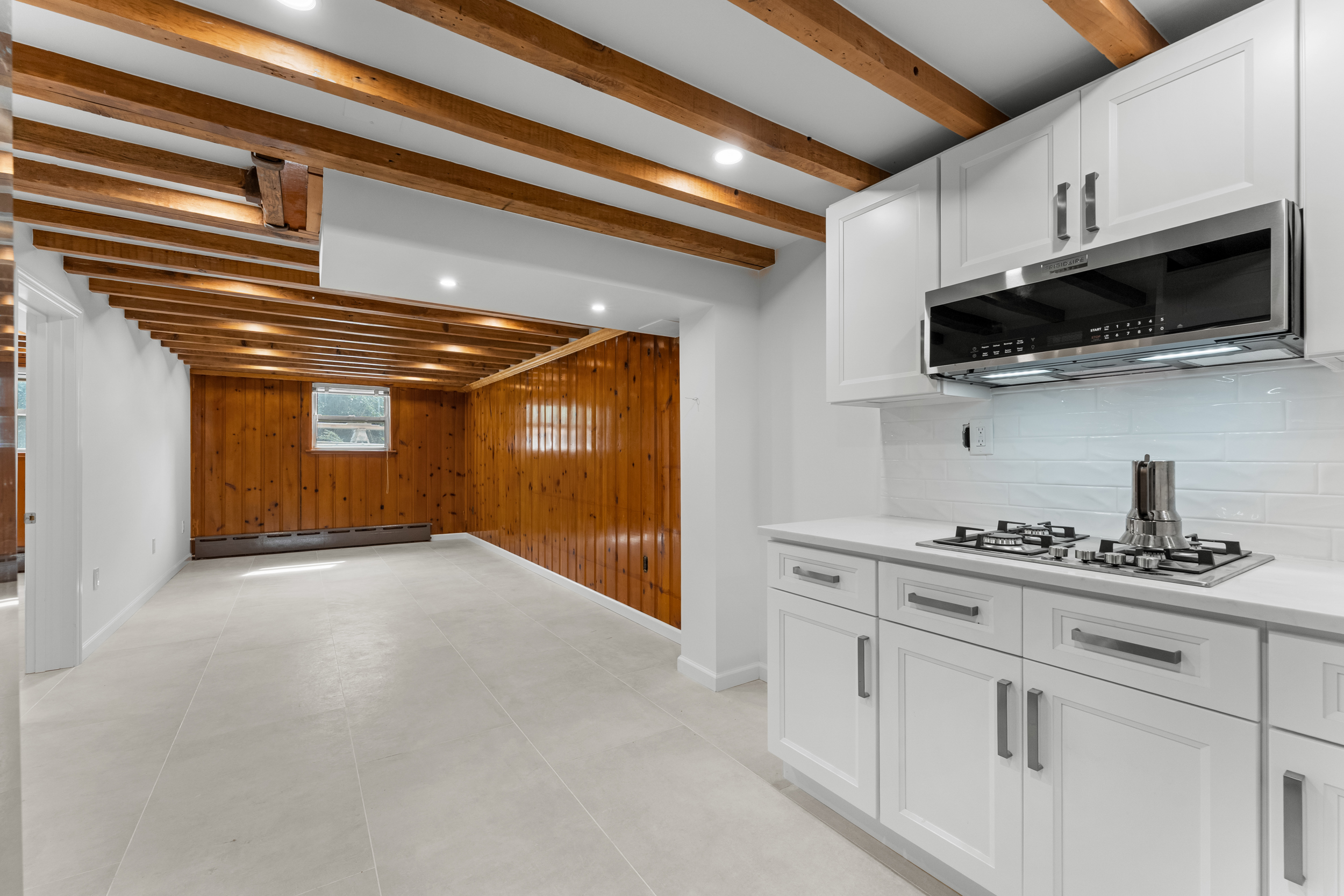 412 Fairview Avenue, Unit GARDEN Queens, NY 11385 - Photo 3 of 14 a kitchen with stainless steel appliances granite countertop a sink a stove and microwave