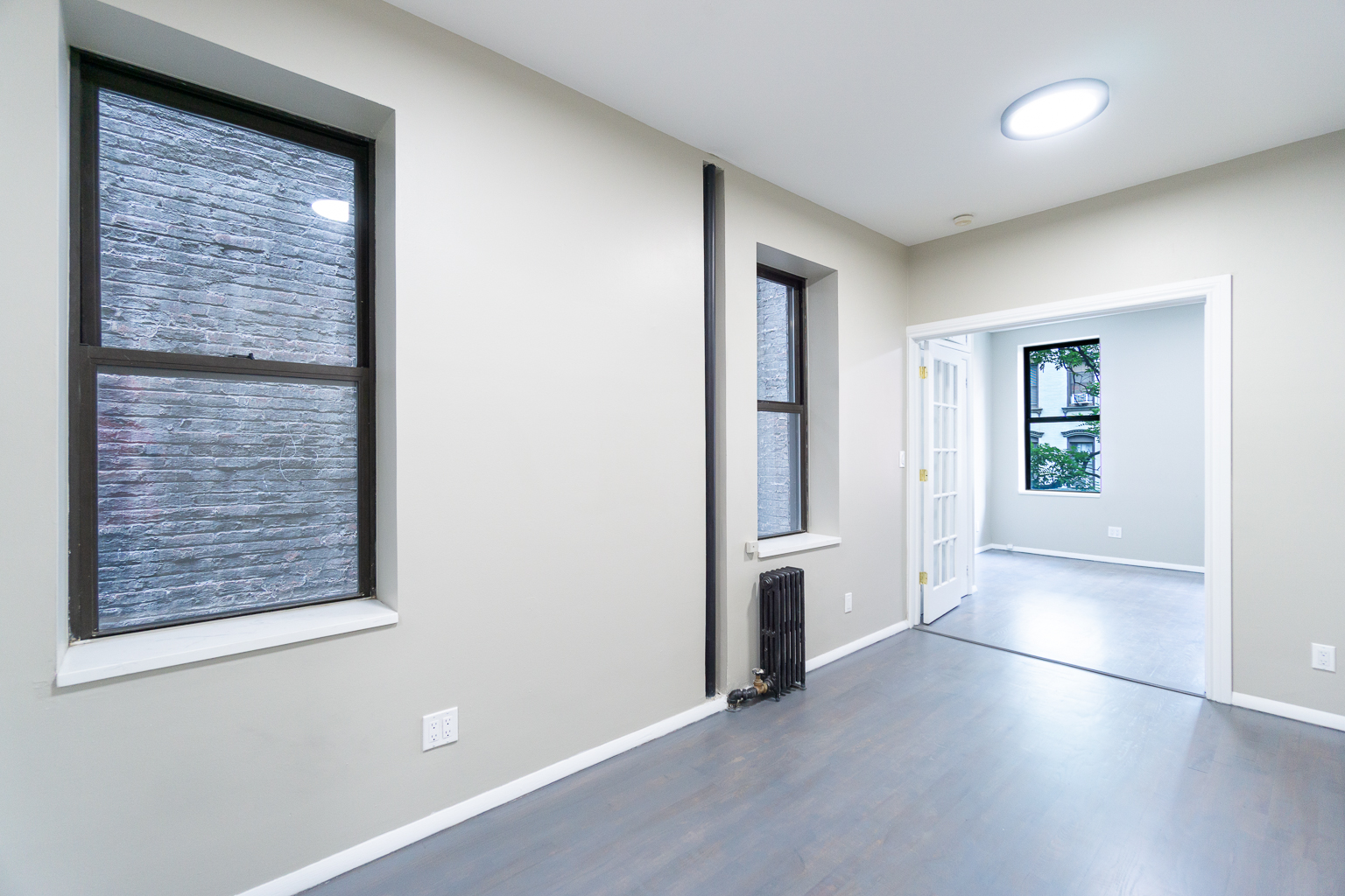 338 East 5th Street, Unit 5 Manhattan, NY 10003 - Photo 3 of 11 an empty room with windows