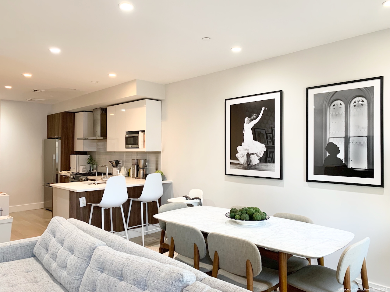 a view of a dining room with furniture a rug and wooden floor