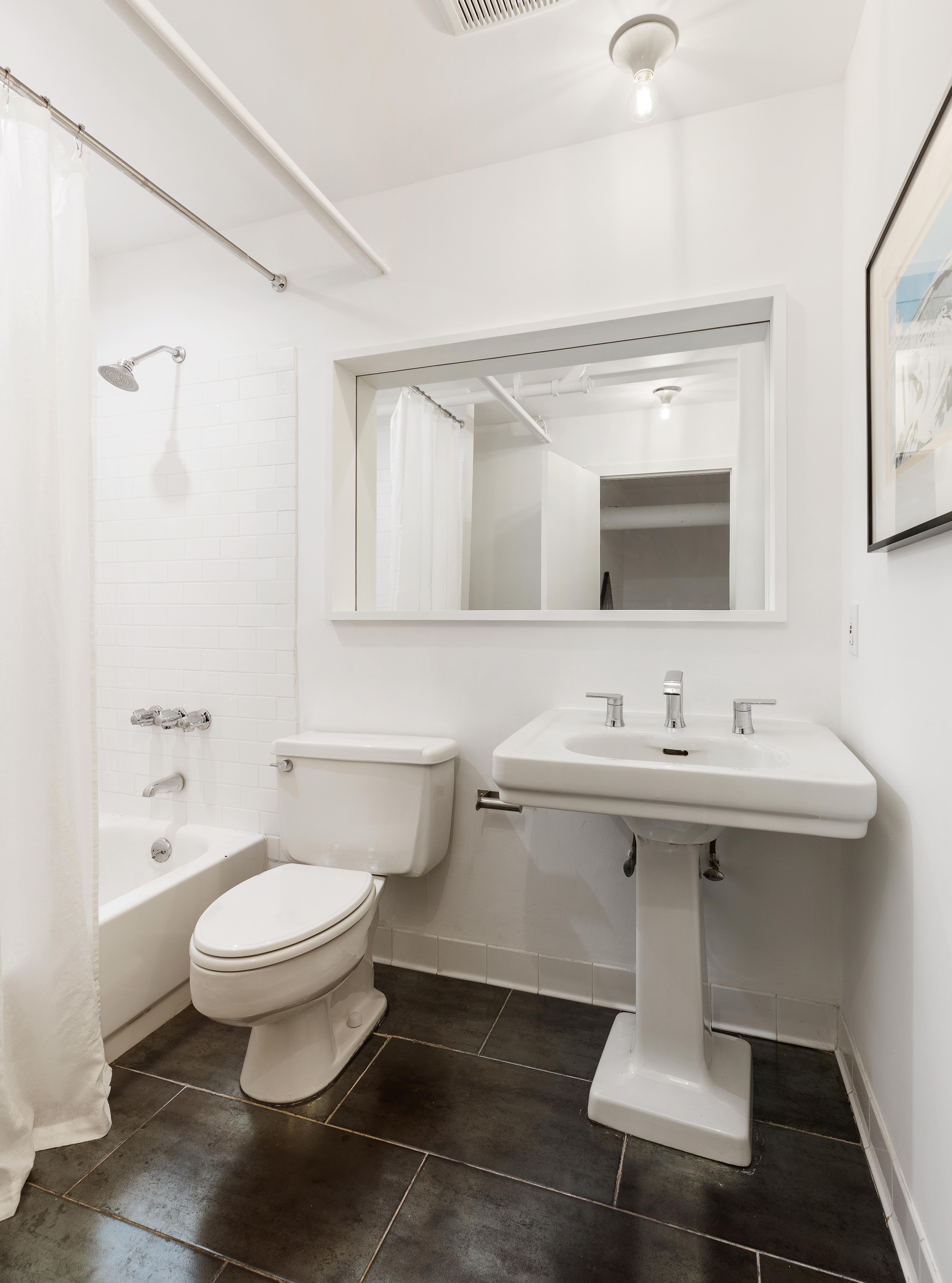 144 Franklin Street, Unit B Manhattan, NY 10013 - Photo 13 of 14 a bathroom with a sink toilet and mirror