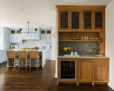 a living room with stainless steel appliances kitchen island granite countertop furniture and a fireplace