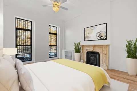 a spacious bedroom with a balcony a bed and a window