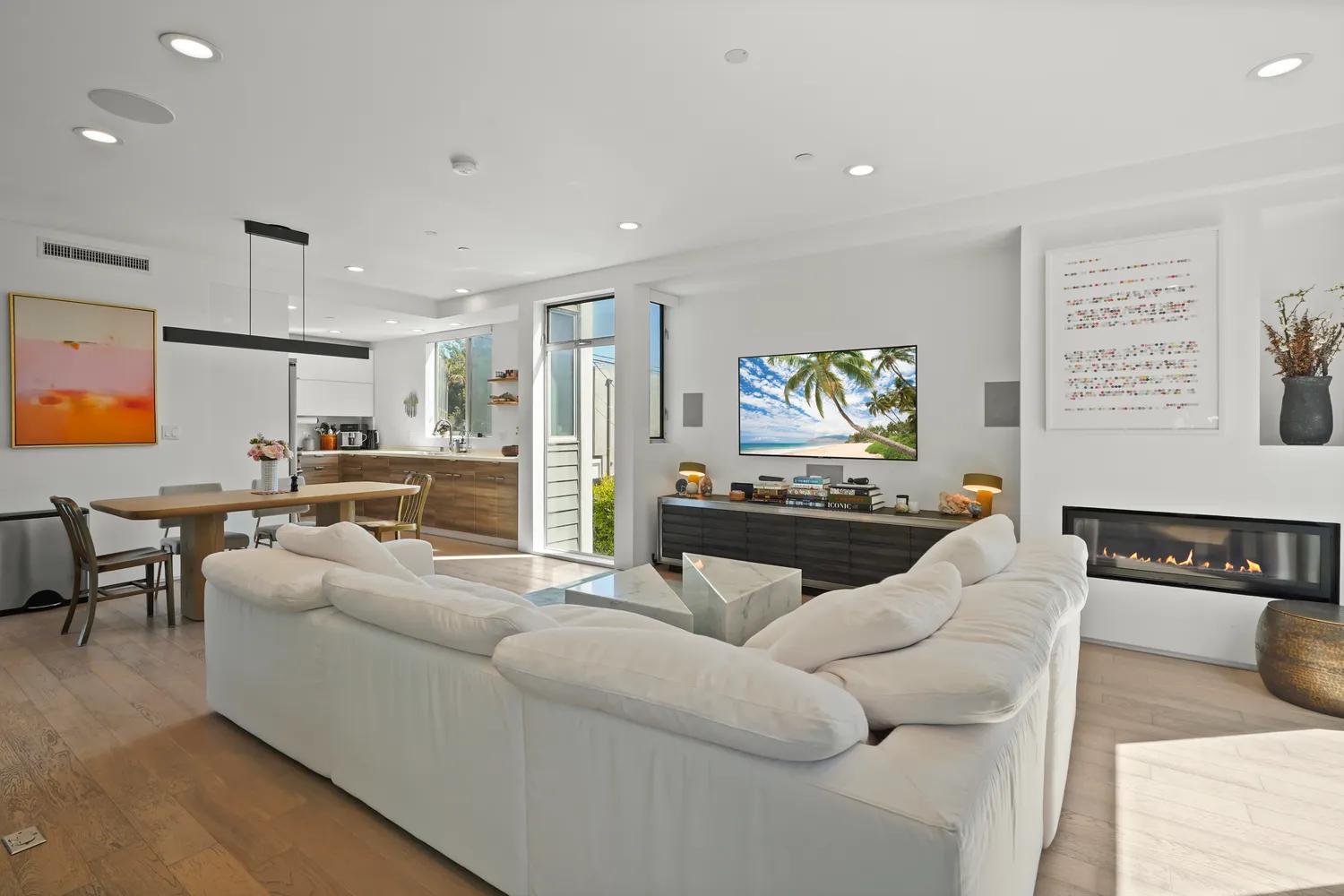 a living room with furniture kitchen view and a window