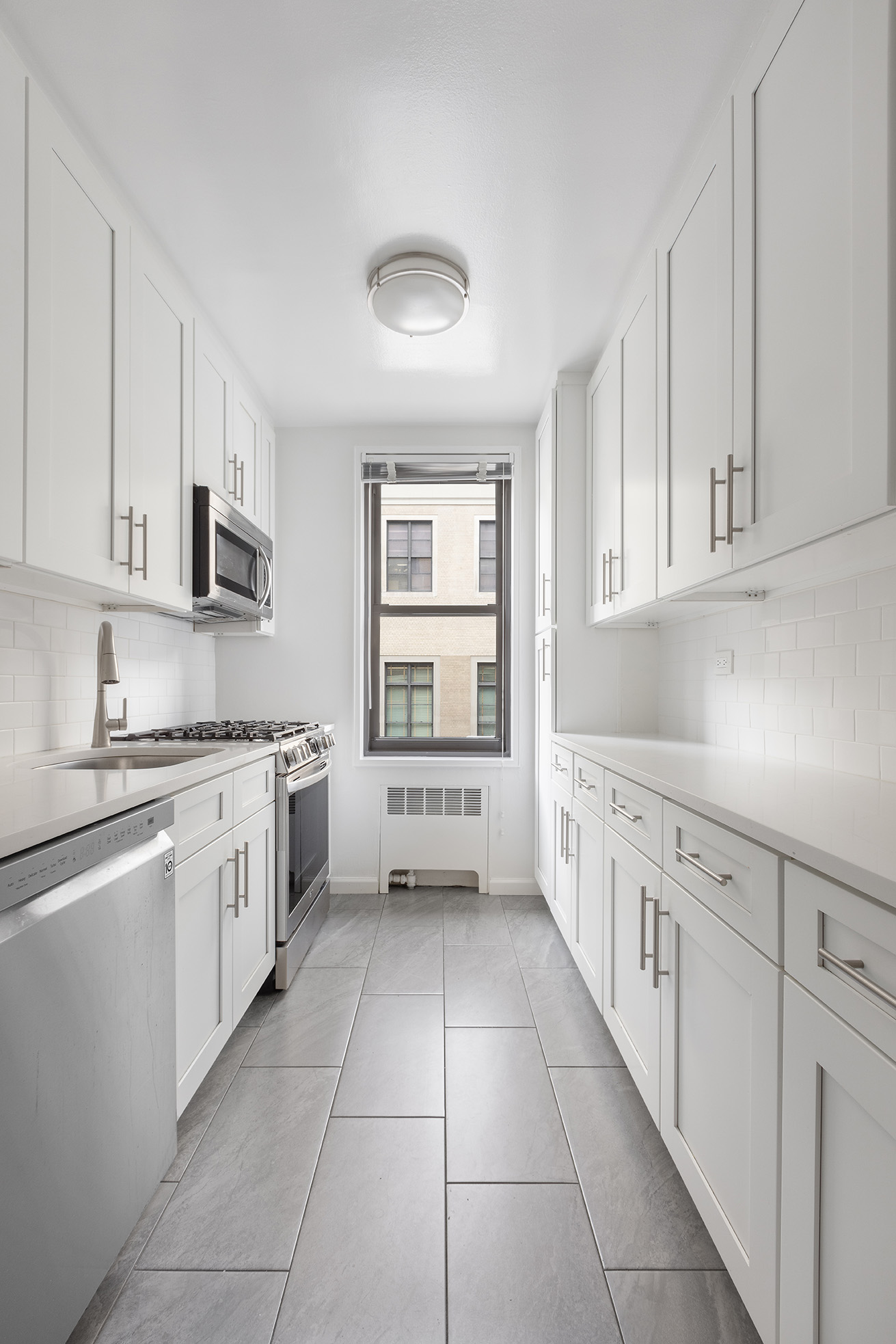 85 4th Avenue, Unit 3FF Manhattan, NY 10003 - Photo 2 of 9 a kitchen with cabinets and window