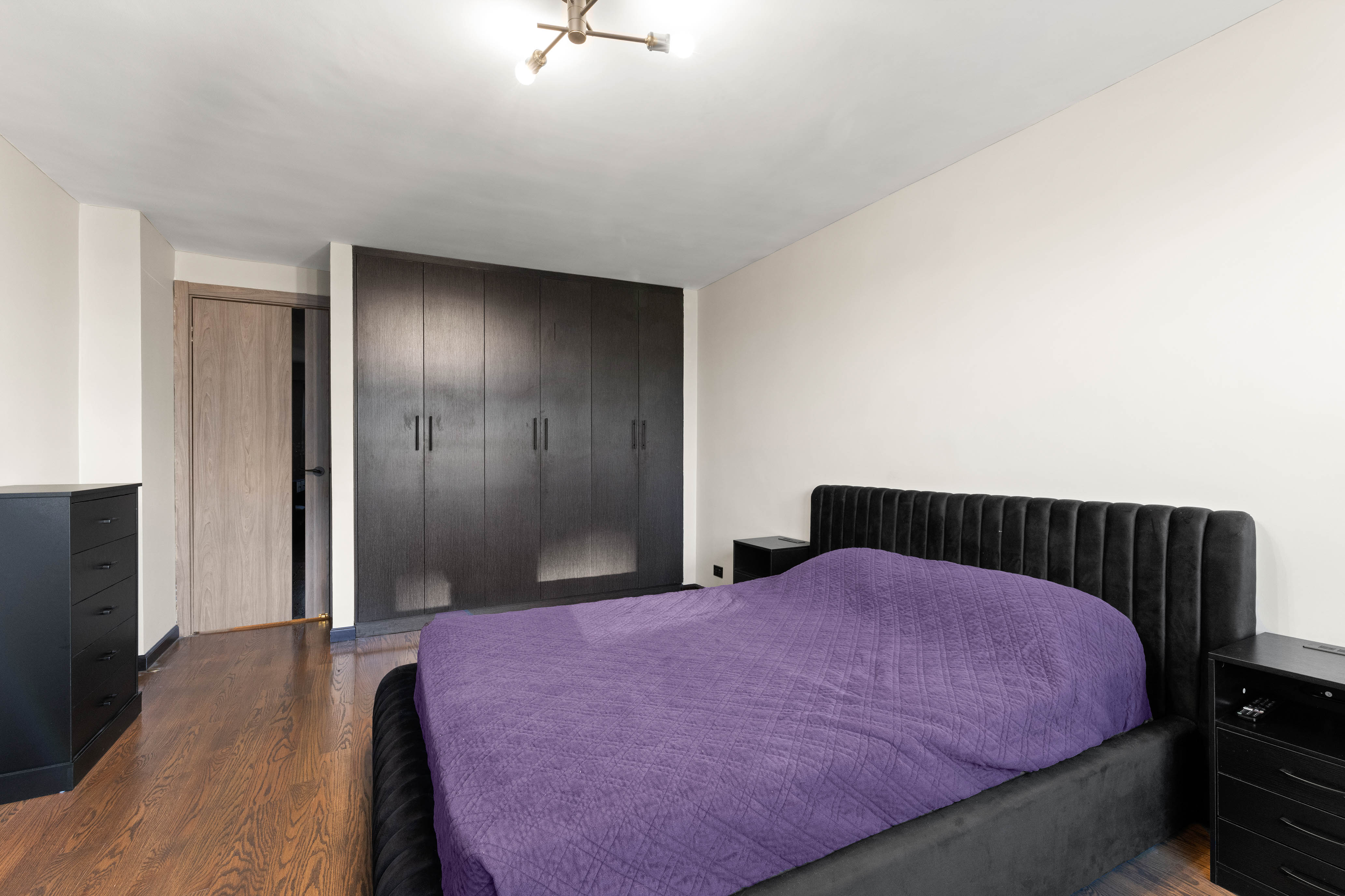 102-10 66th Road, Unit K25 Queens, NY 11375 - Photo 11 of 19 a bedroom with a bed and a dresser