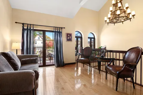 a view of a livingroom with furniture window and wooden floor