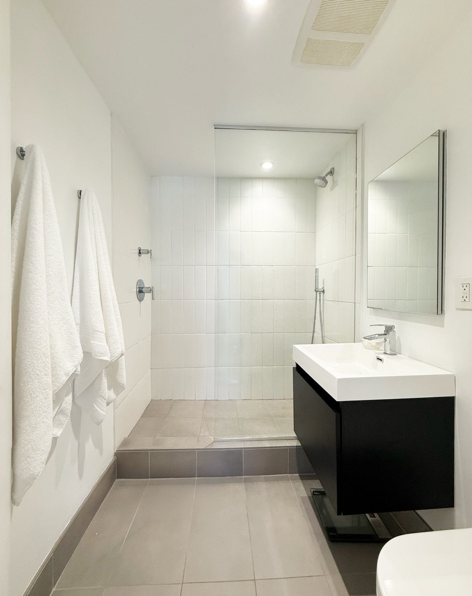 25-40 Shore Boulevard, Unit 3P Queens, NY 11102 - Photo 6 of 21 a bathroom with a sink a toilet and shower