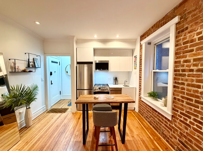 223 East 50th Street, Unit 1C Manhattan, NY 10022 - Photo 4 of 10 a view of a workspace with furniture and wooden floor