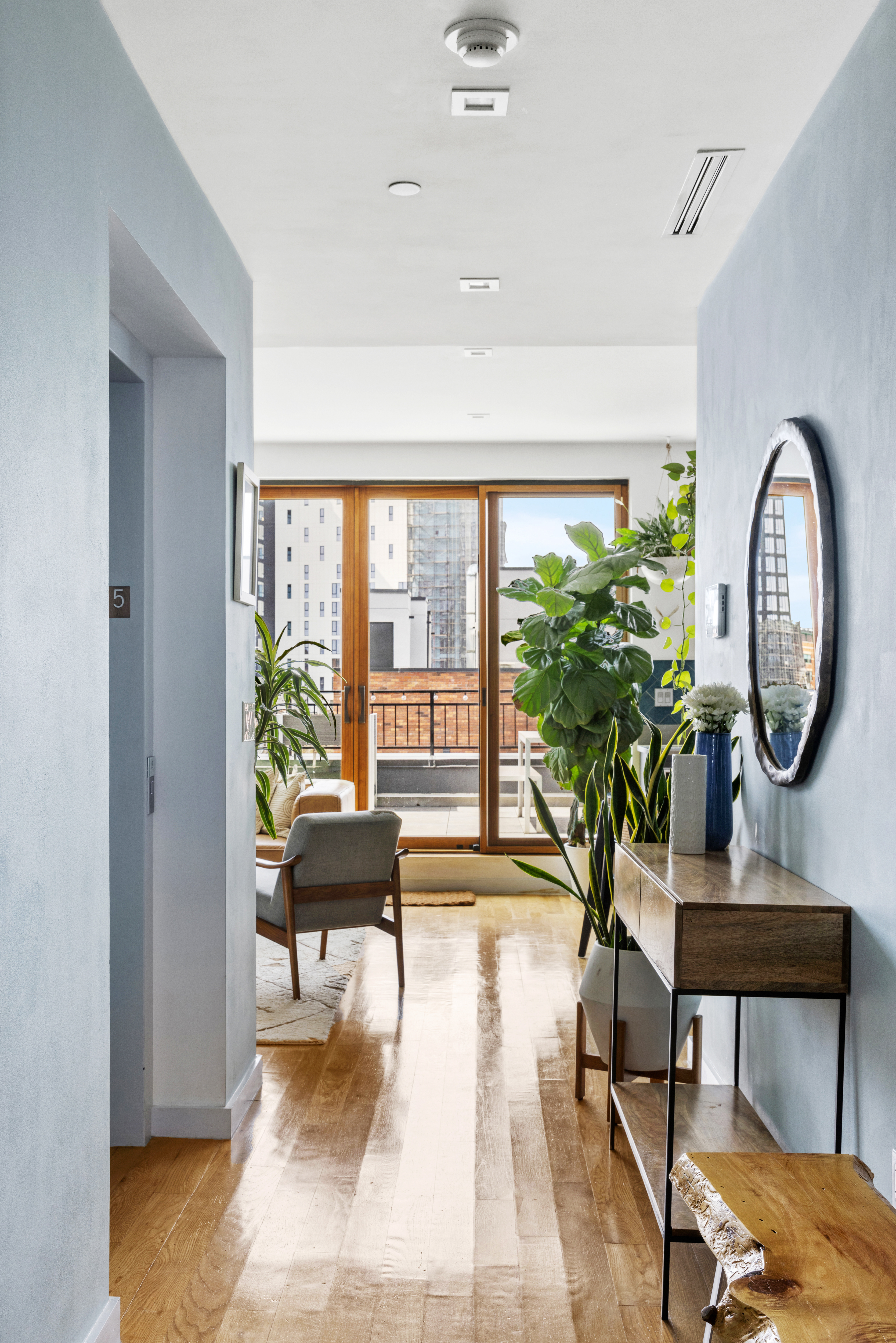 64 Stanhope Street, Unit PH Brooklyn, NY 11221 - Photo 5 of 13 a living room with furniture and a large window