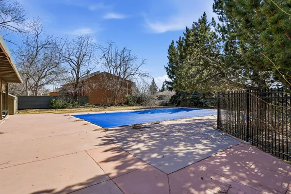 a view of swimming pool with outdoor seating and plants