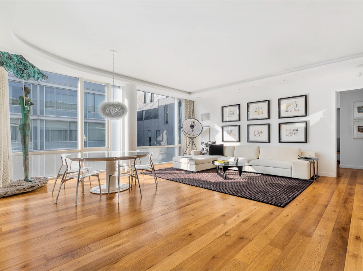 311 West Broadway, Unit 6J Manhattan, NY 10013 - Photo 2 of 19 a living room with furniture a dining table and wooden floor