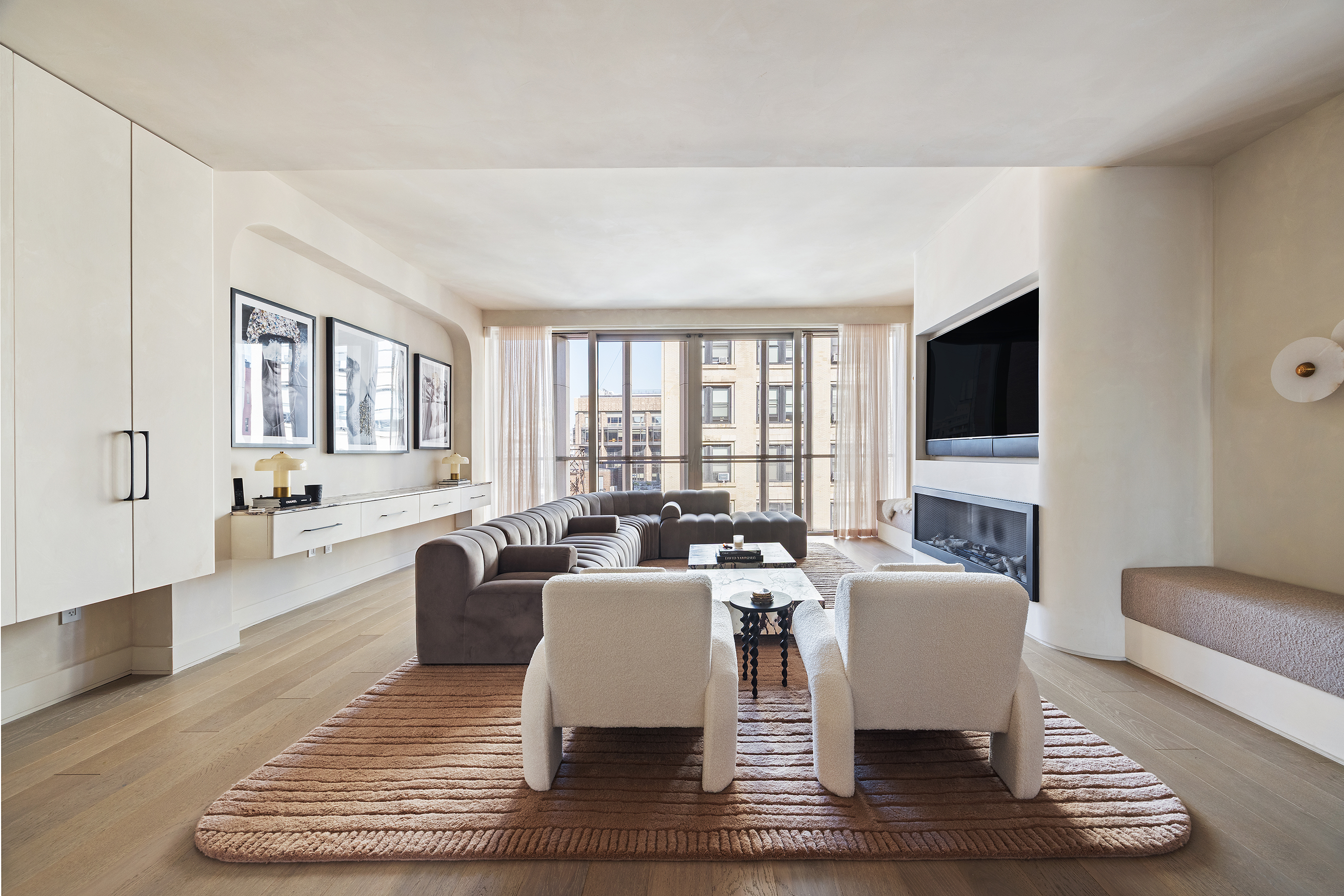 1 Great Jones Alley, Unit 10 Manhattan, NY 10012 - Photo 4 of 41 a living room with fireplace furniture and a flat screen tv