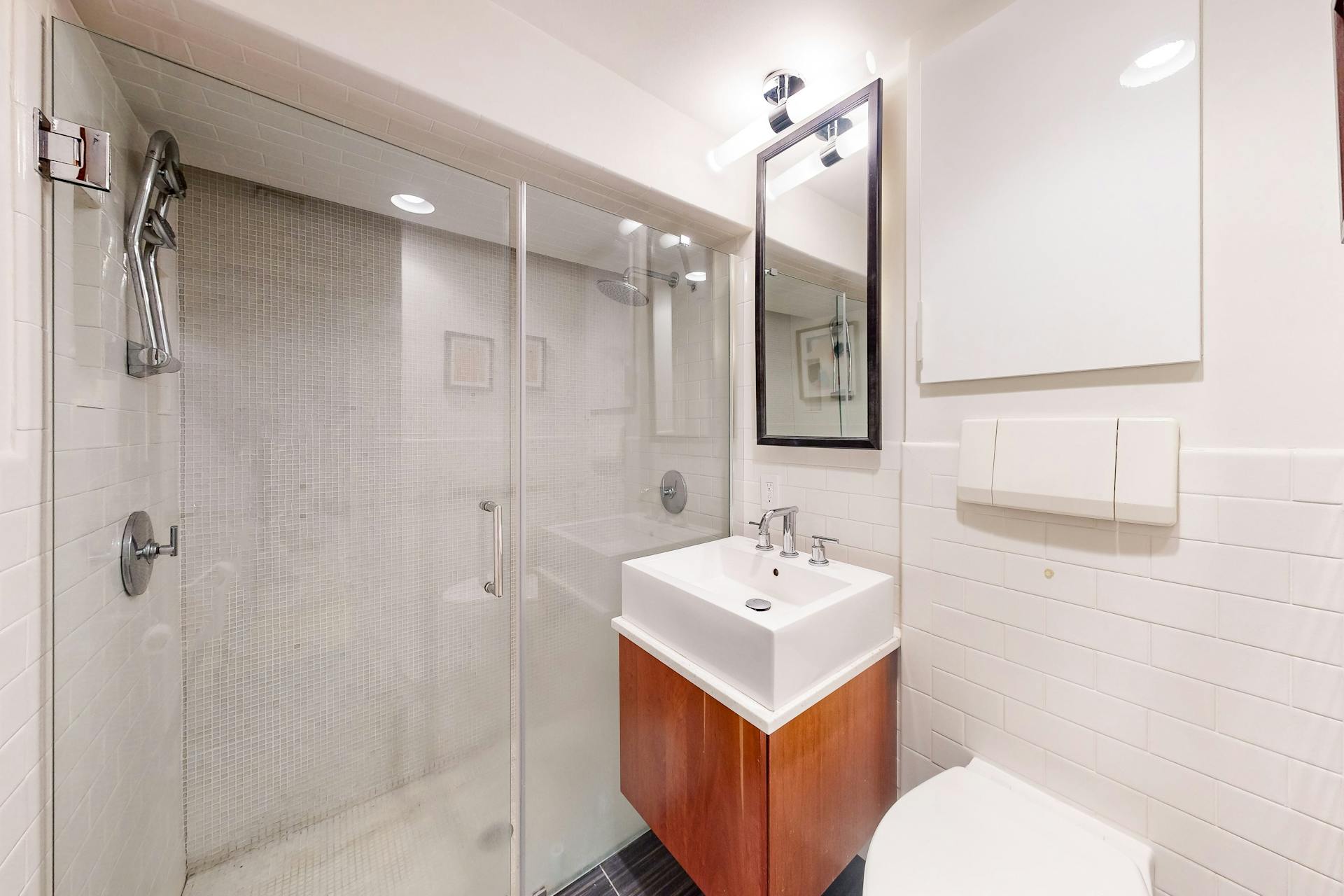 11 Fayette Street, Unit 1 Boston, MA 02116 - Photo 25 of 33 a bathroom with a sink toilet double vanity and shower