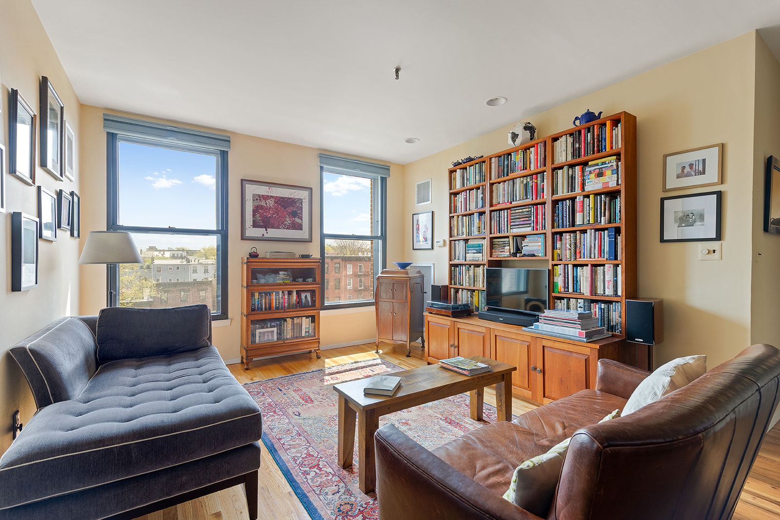 1 Tiffany Place, Unit 4B Brooklyn, NY 11231 - Photo 2 of 6 a living room with furniture and a book shelf