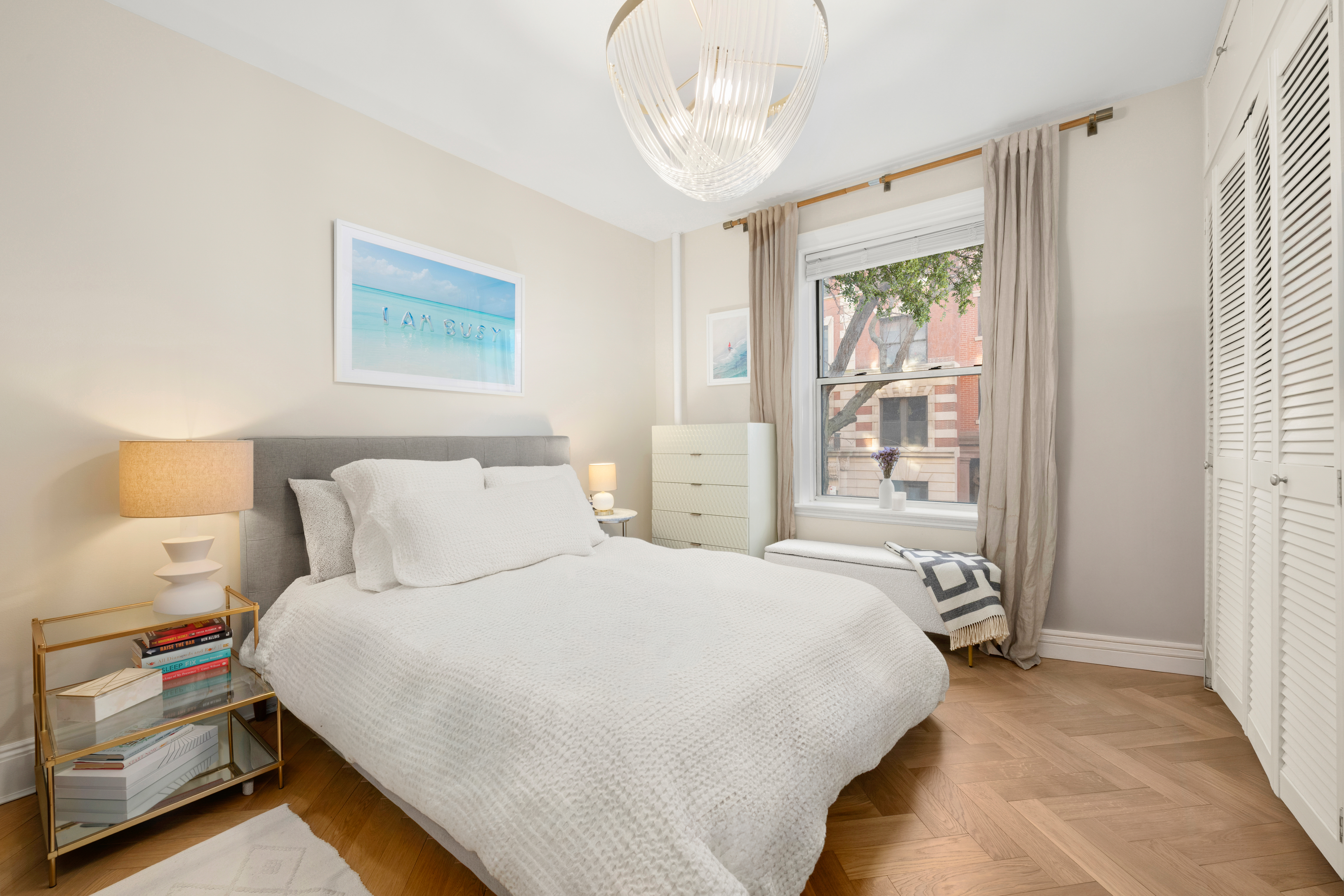 233 West 21st Street, Unit 2B Manhattan, NY 10011 - Photo 4 of 9 a bedroom with a bed and a window
