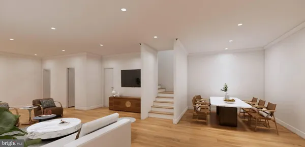 a view of a kitchen with furniture and wooden floor
