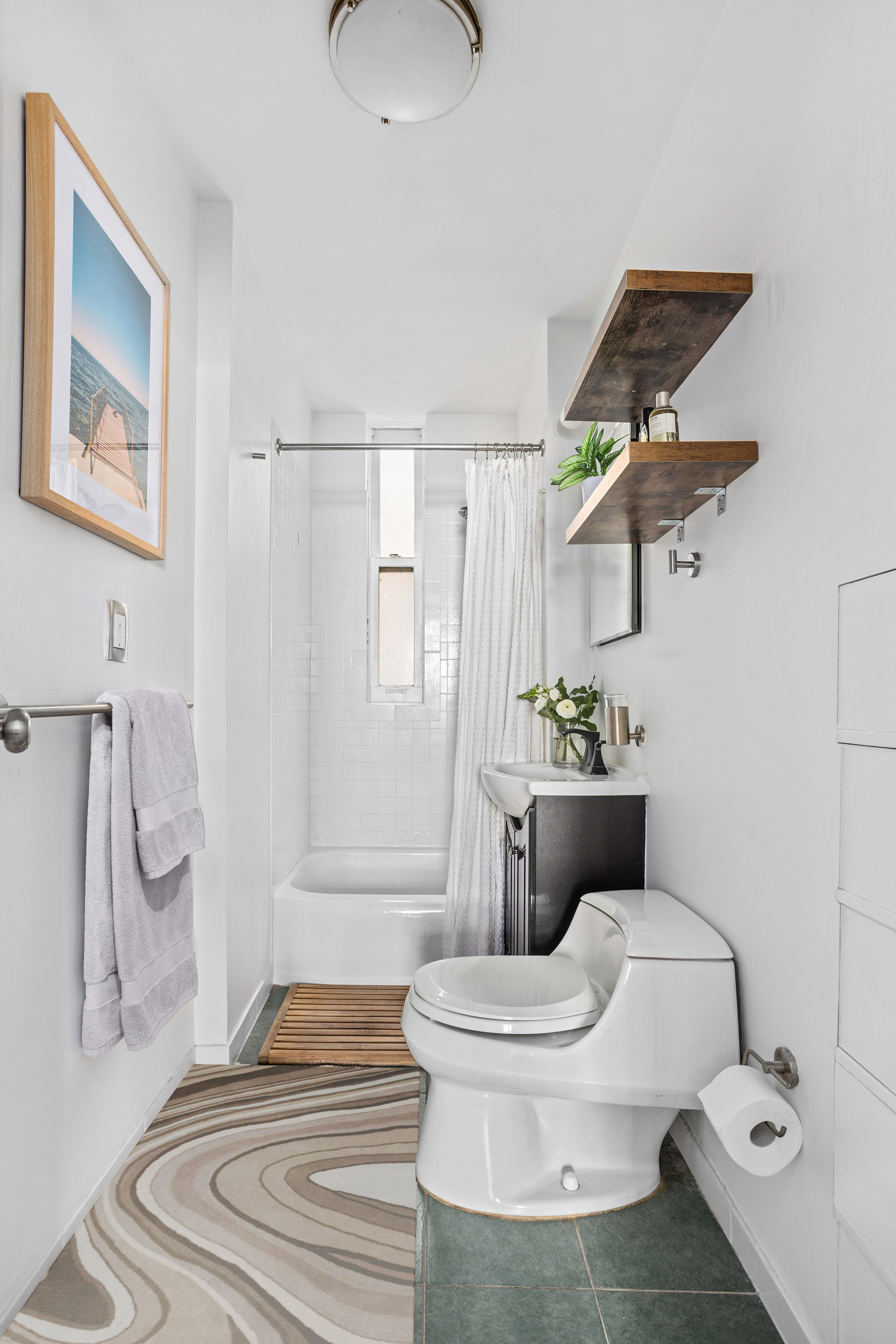 335 West 21st Street, Unit 3RE Manhattan, NY 10011 - Photo 5 of 7 a bathroom with a sink toilet and shower