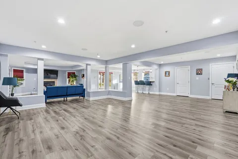 a view of empty room with wooden floor and windows