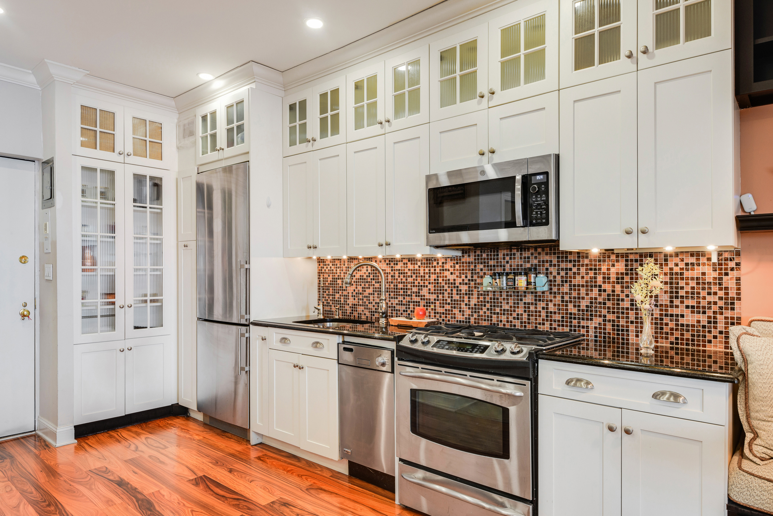a kitchen with stainless steel appliances granite countertop a stove and a microwave