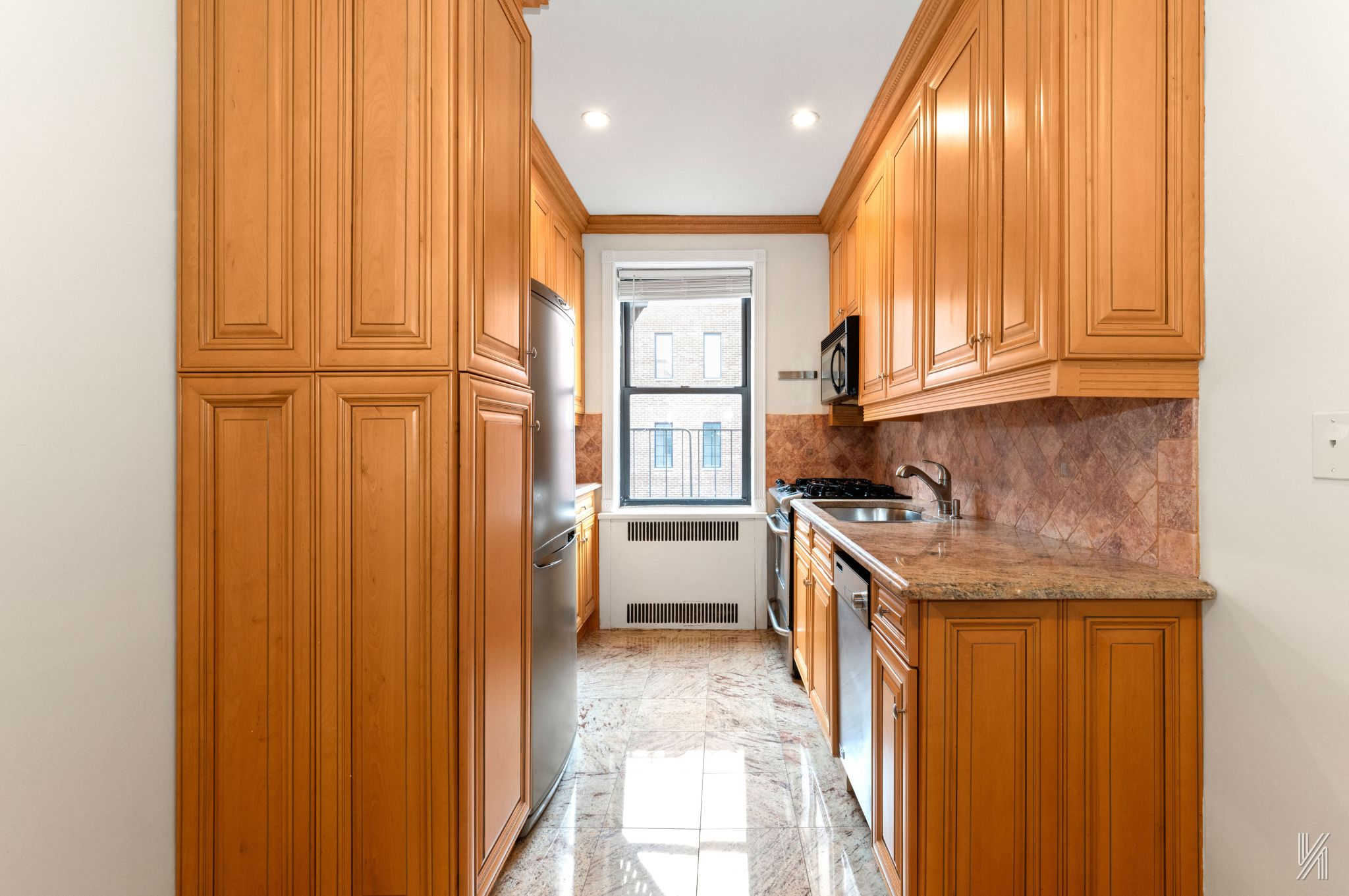 25-40 31st Avenue, Unit 6E Queens, NY 11106 - Photo 9 of 15 a kitchen with granite countertop cabinets and black stainless steel appliances