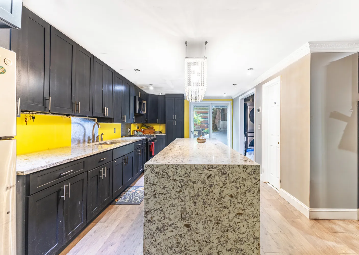 a kitchen with stainless steel appliances granite countertop a sink and a refrigerator