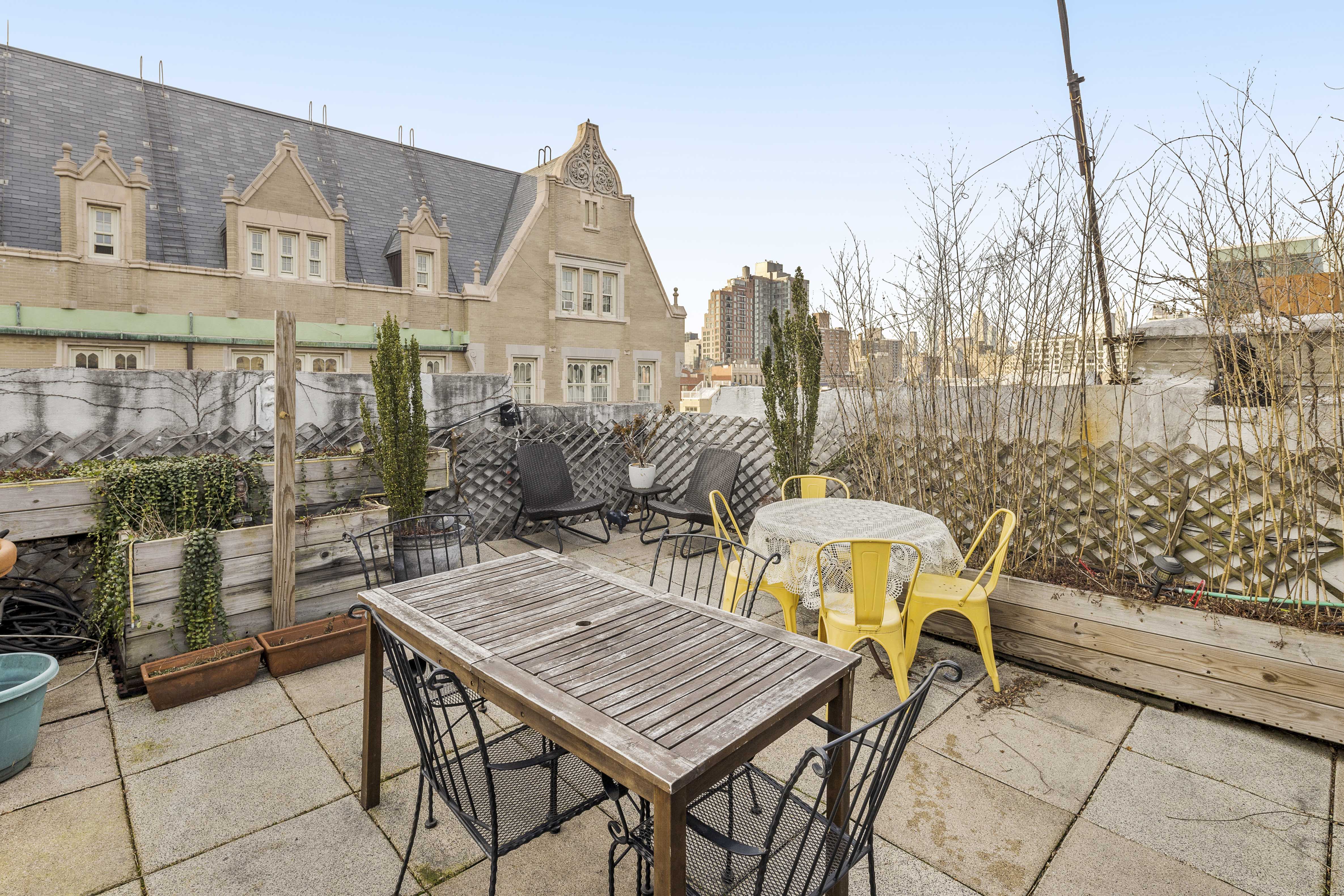 120 Suffolk Street, Unit 5B Manhattan, NY 10002 - Photo 12 of 14 a view of a patio with table and chairs and potted plants