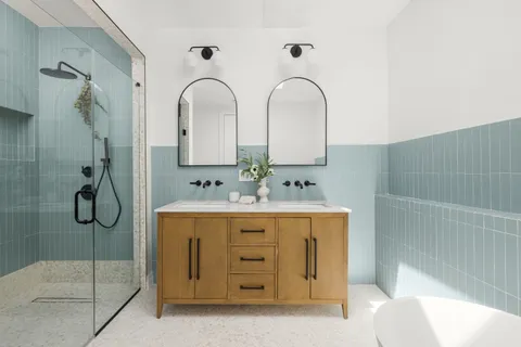 a bathroom with a sink a toilet and shower