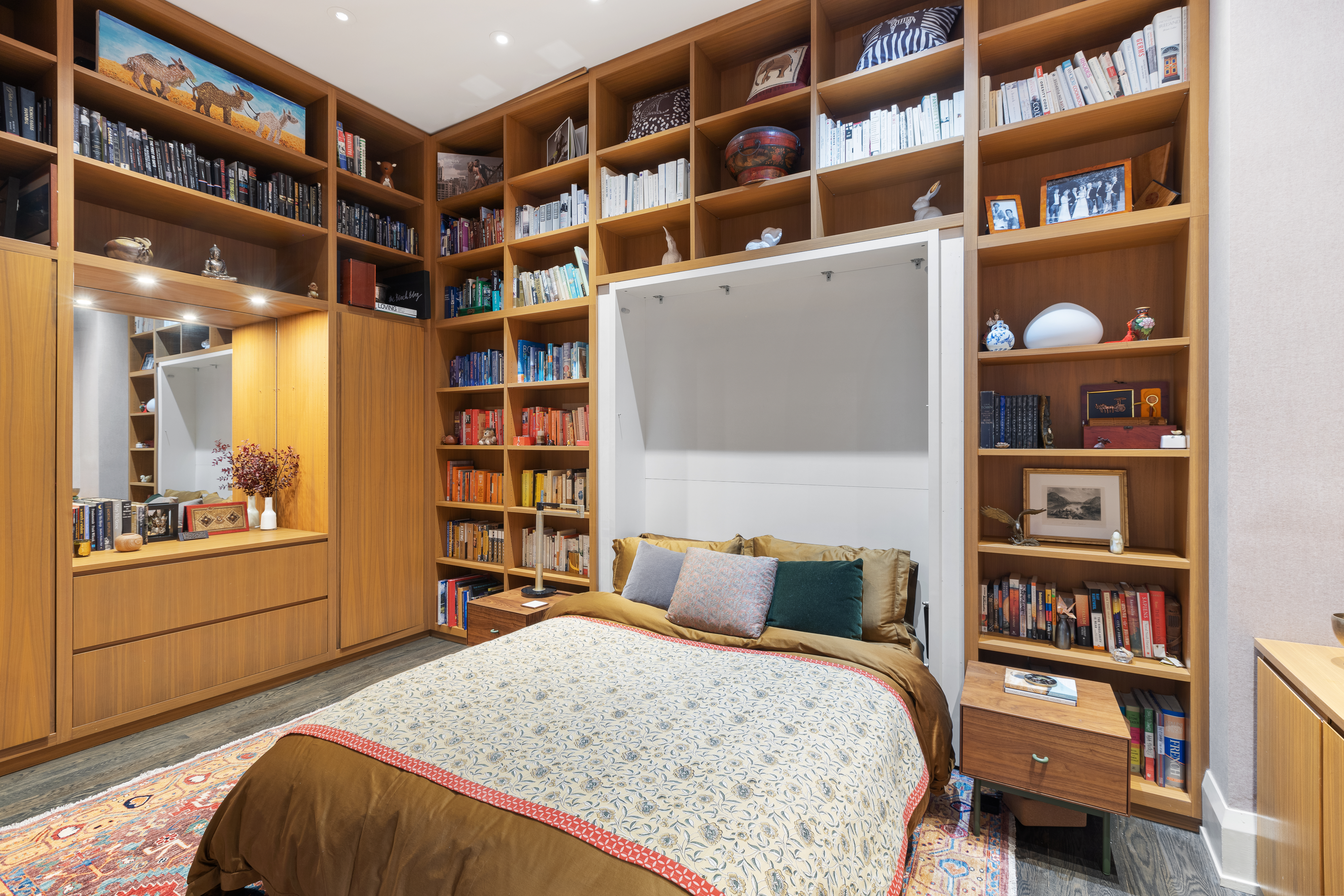 263 9th Avenue, Unit 2E Manhattan, NY 10001 - Photo 6 of 12 a bedroom with a bed and a book shelf