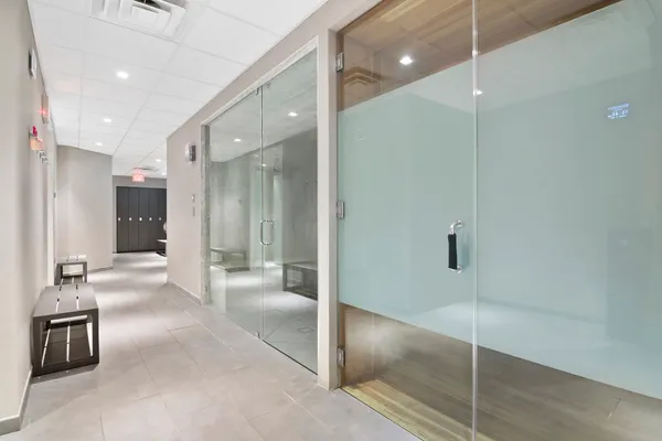 a bathroom with a glass shower door and a sink