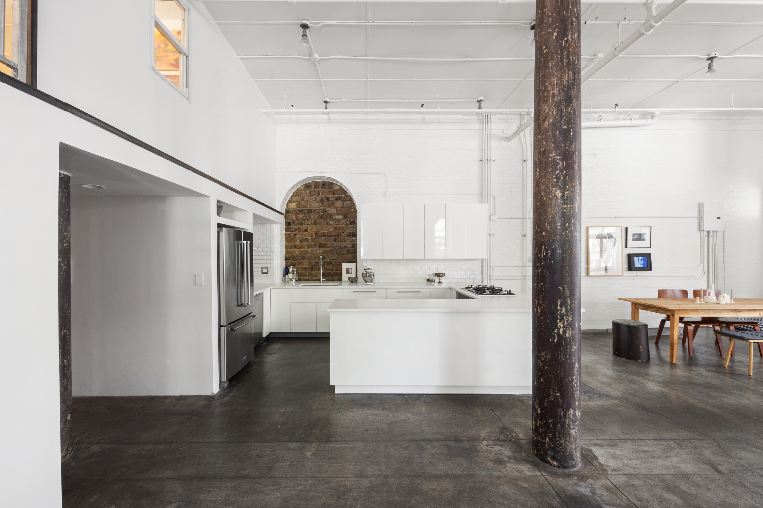 125 Watts Street, Unit 1 Manhattan, NY 10013 - Photo 9 of 24 a view of open kitchen with furniture and refrigerator