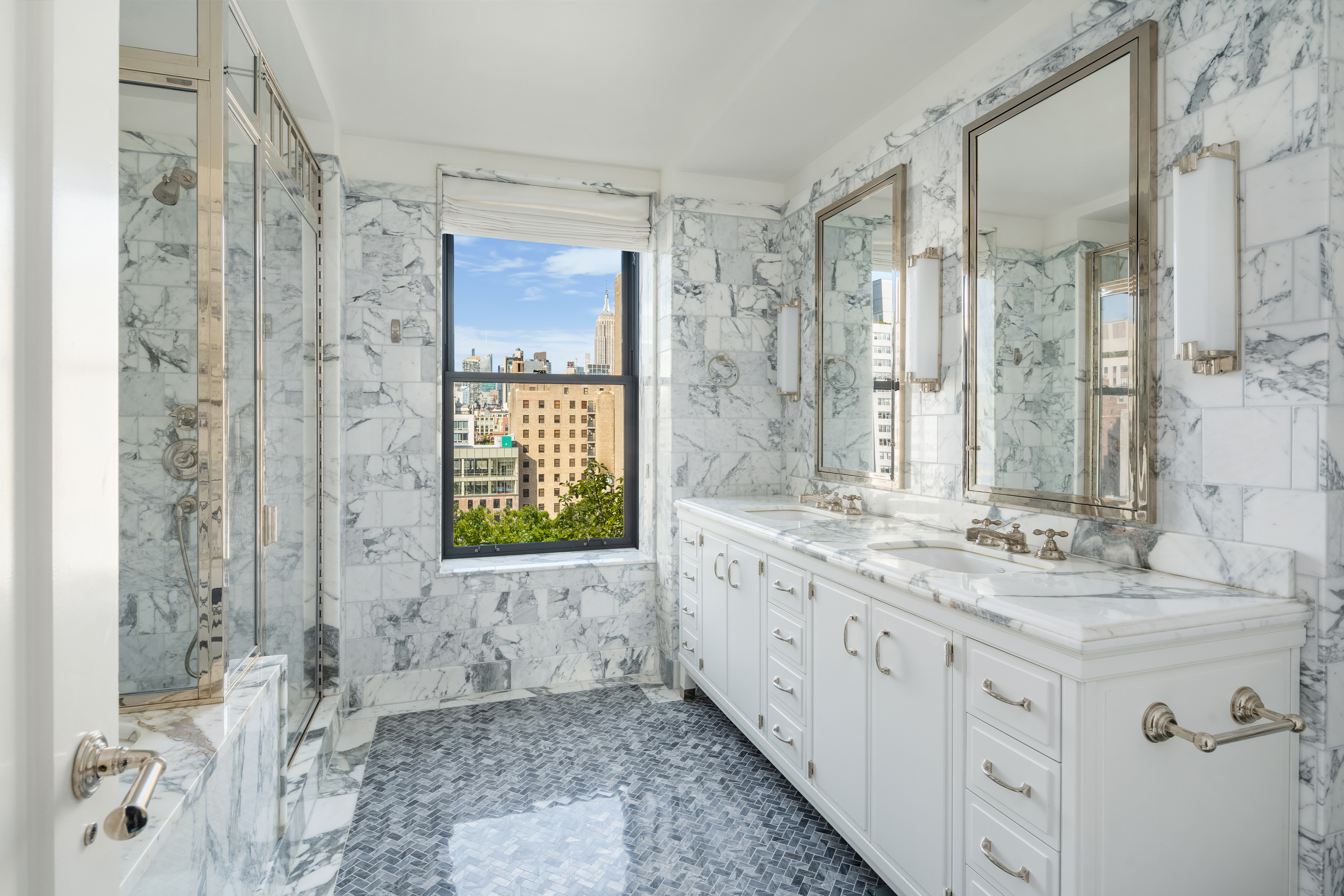 150 West 12th Street, Unit 11E Manhattan, NY 10011 - Photo 9 of 15 a bathroom with a granite countertop double vanity sink a mirror and a shower