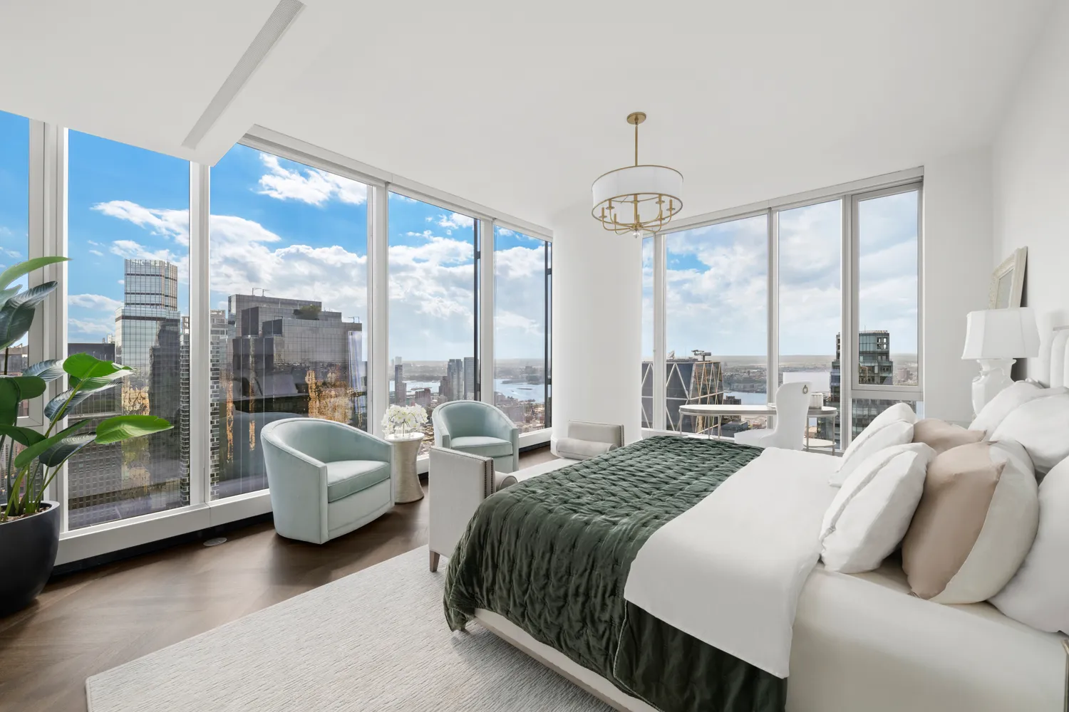 a bedroom with furniture and large windows