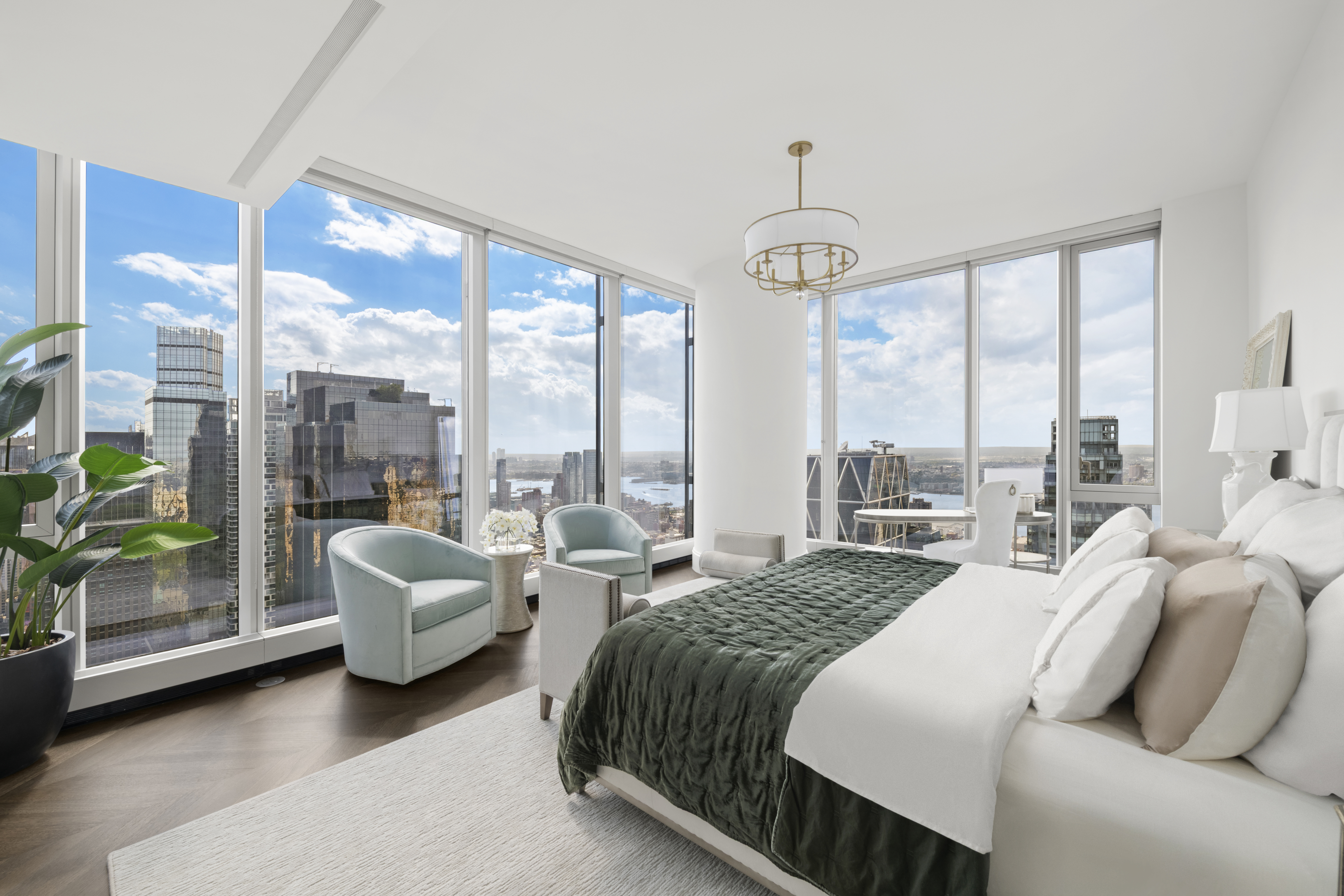 217 West 57th Street, Unit 58W Manhattan, NY 10019 - Photo 10 of 30 a bedroom with furniture and large windows
