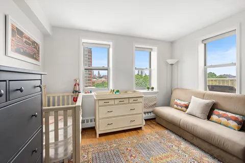 a bedroom with furniture and a window