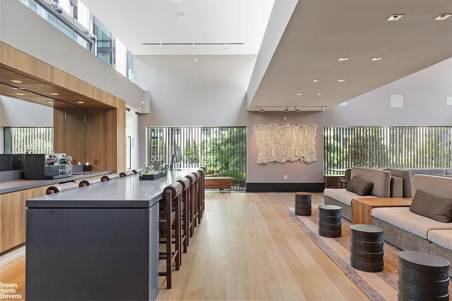 a room with furniture a large window and wooden floors