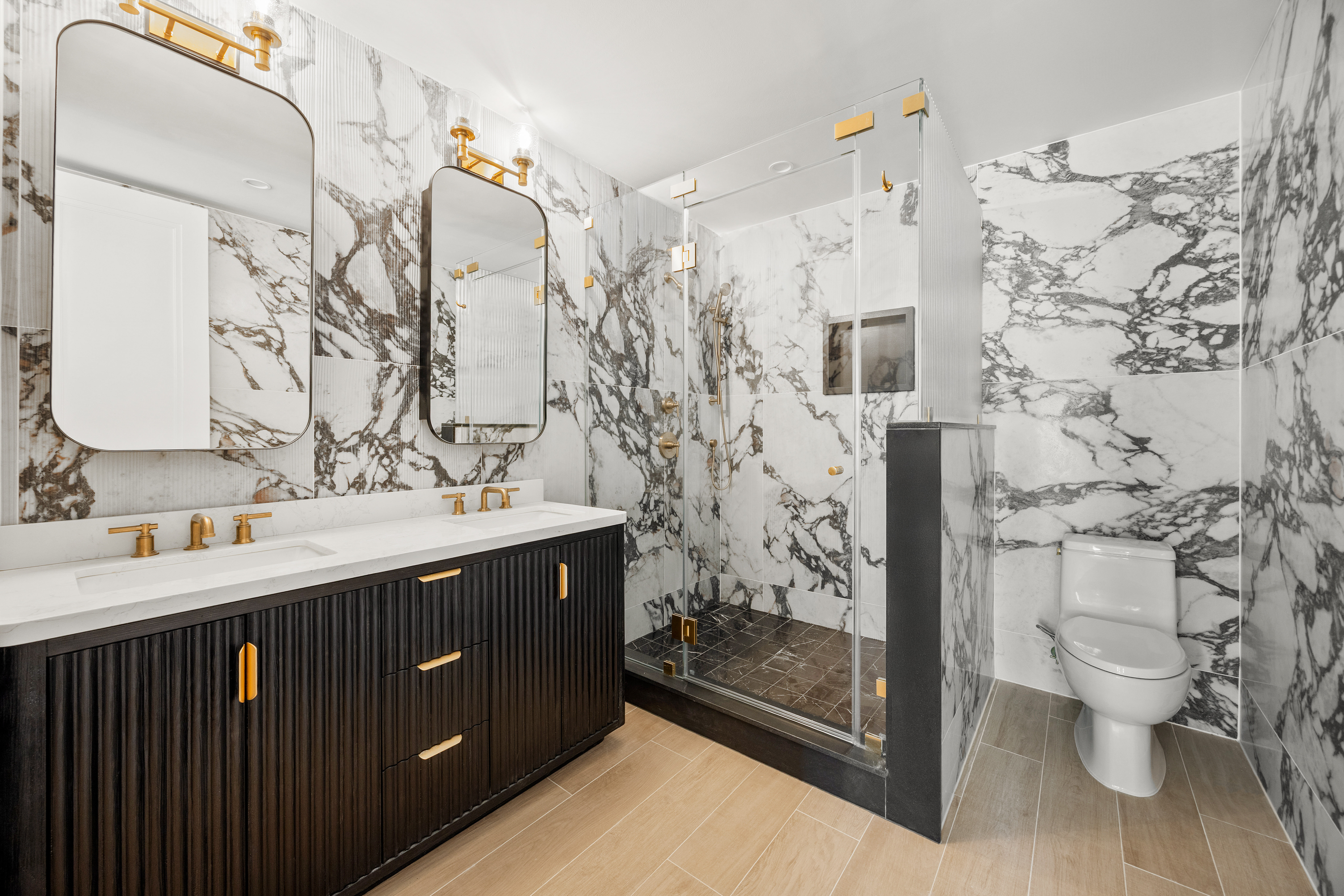 354 Dean Street, Unit 3 Brooklyn, NY 11217 - Photo 9 of 18 a bathroom with a double vanity sink toilet and shower