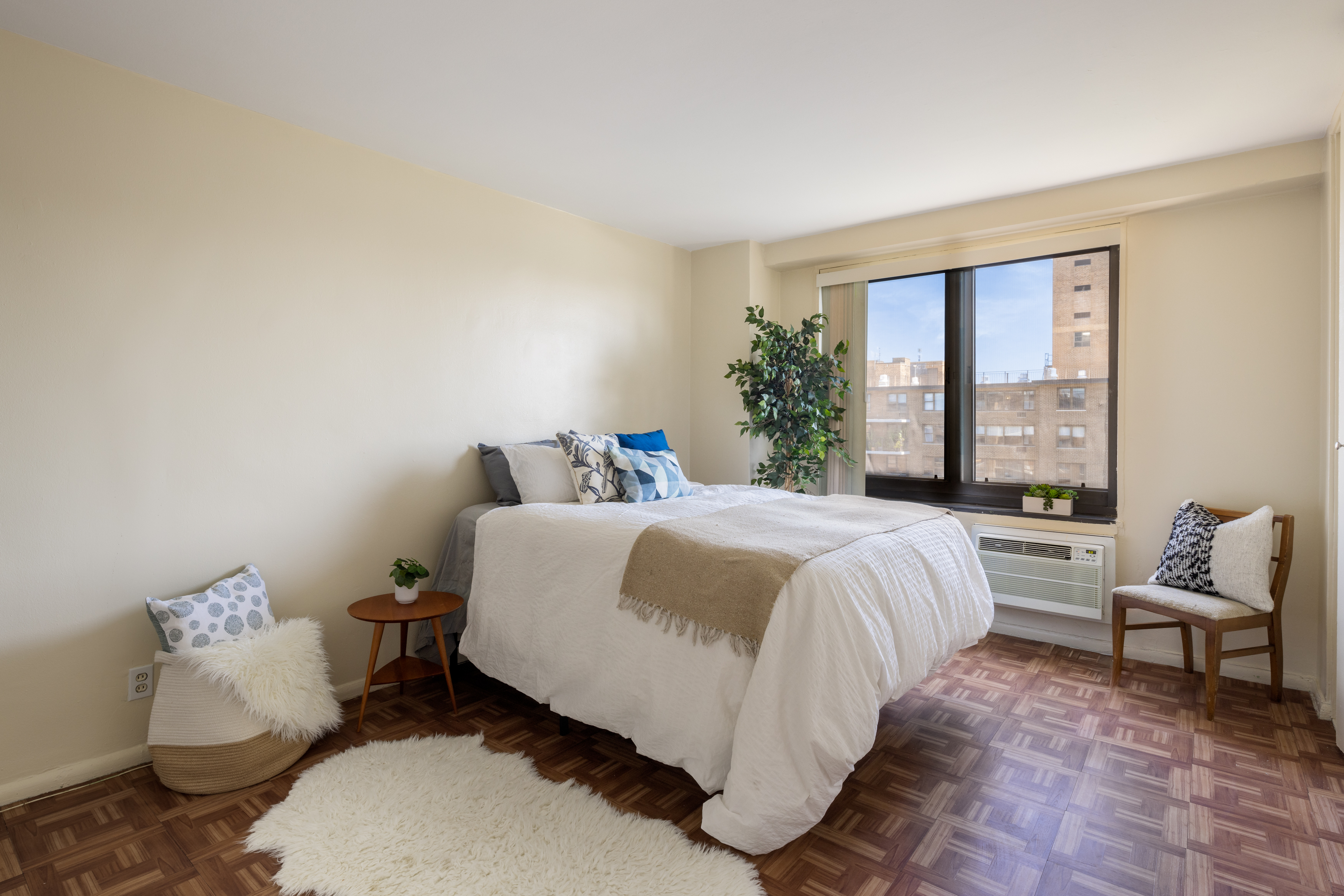 195 Willoughby Avenue, Unit 1610 Brooklyn, NY 11205 - Photo 3 of 7 a spacious bedroom with a bed and large windows